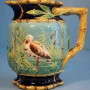 Stork in marsh pitcher with bamboo handle