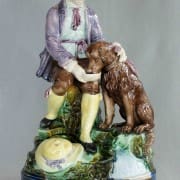 Boy feeding dog figure