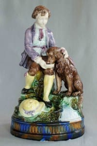 Boy feeding dog figure