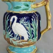 Stork in marsh pitcher with bamboo handle